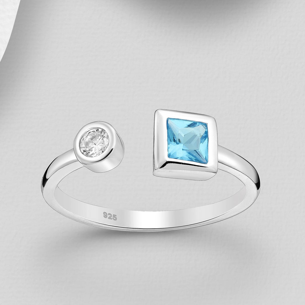 Sterling silver adjustable ring with one round clear crystal and one square colored crystal, comes with gift box.
