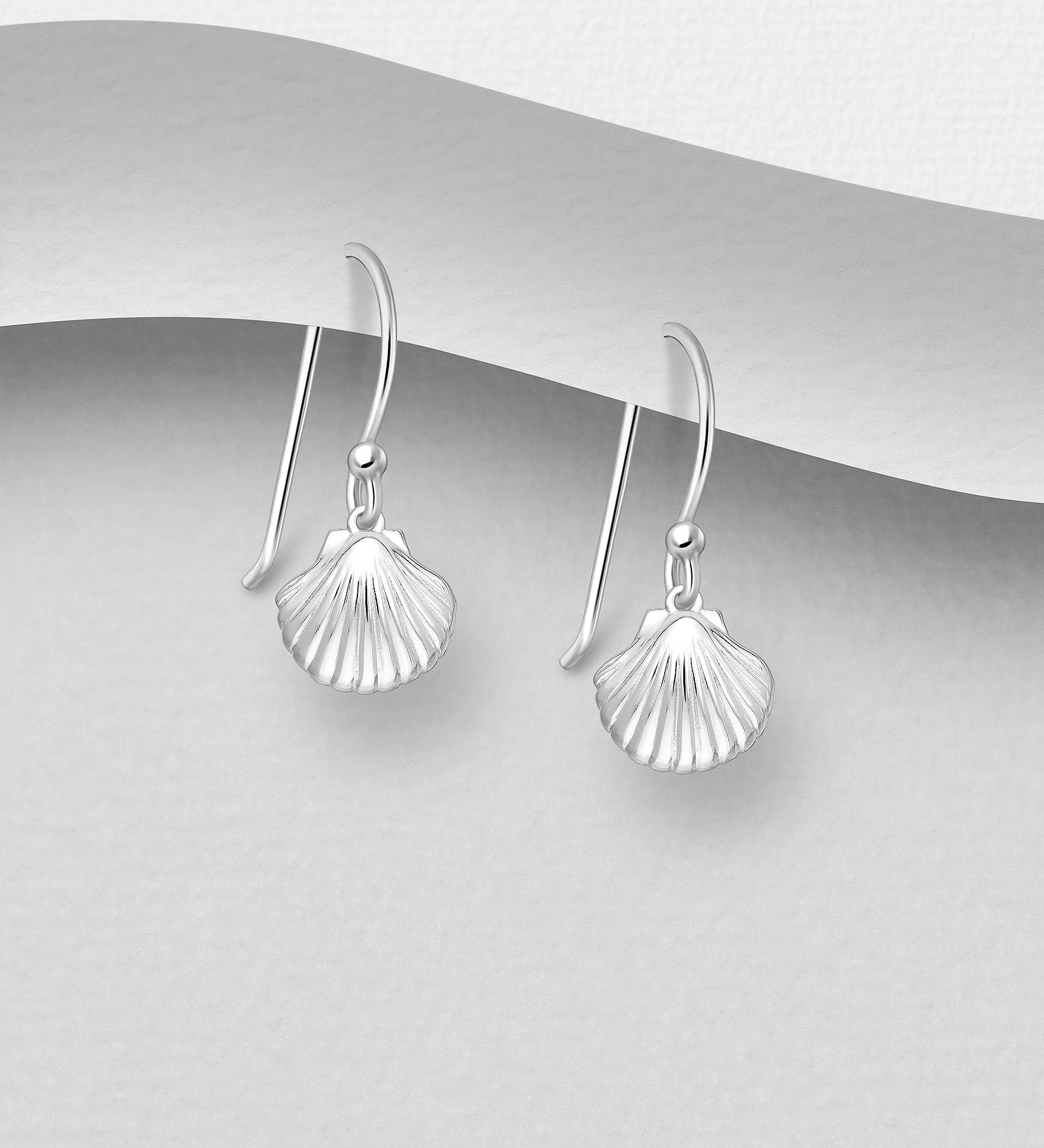 A pair of sterling silver shell drop earrings with French hook fastening, displayed against a white background.
