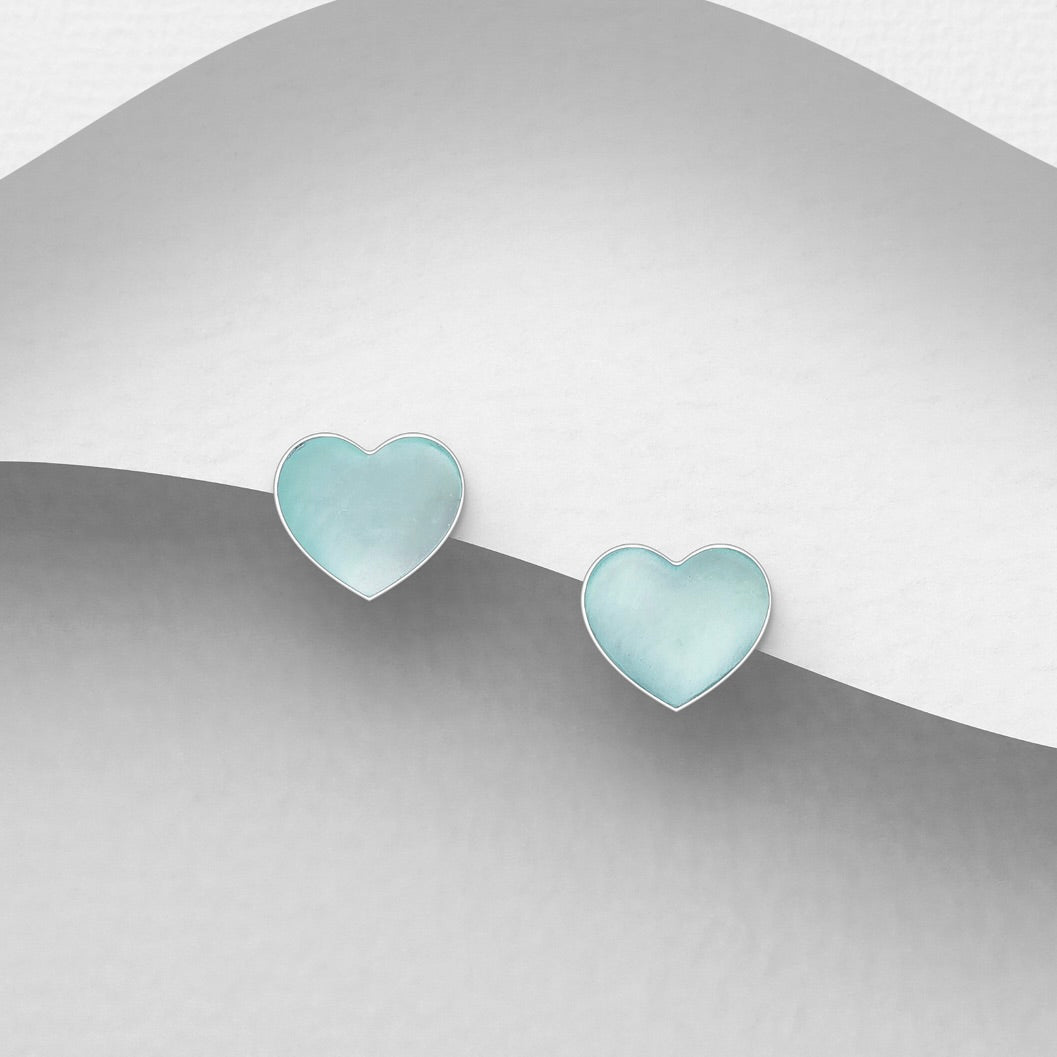 Heart-shaped earrings in Pale Blue MOP on a gradient silver backgrounding