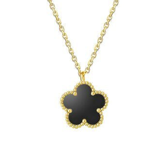 Gold necklace with a black clover pendant on a white background
