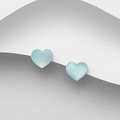 Heart-shaped earrings in Pale Blue MOP on a gradient silver backgrounding 